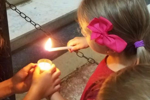 Kids lighting candles at the Vatican